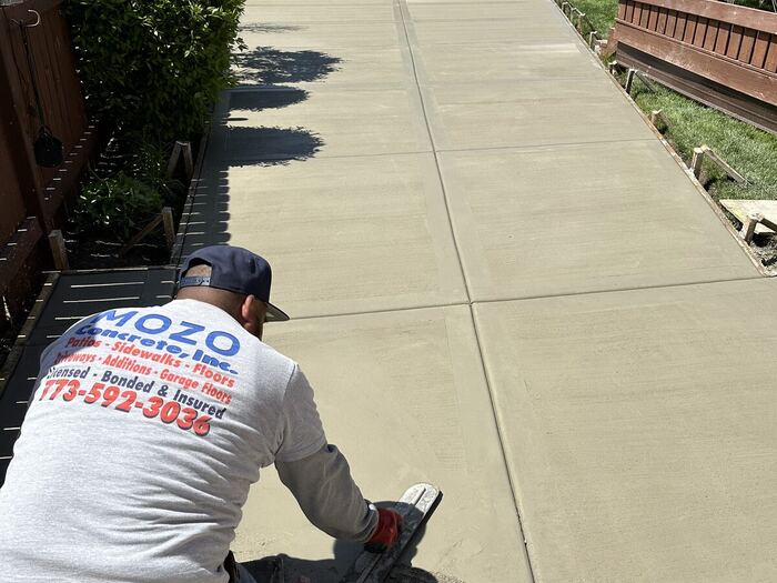 Finishing a freshly poured driveway