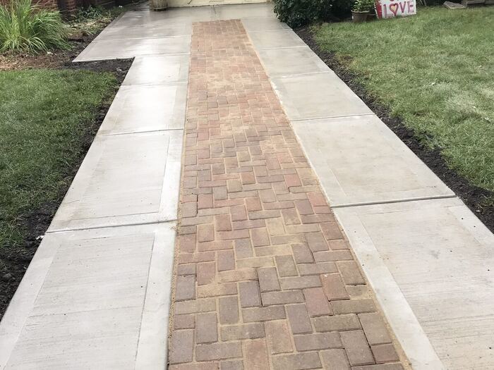 Walkway with a decorative brick paver inlay